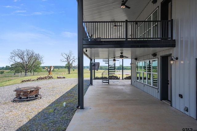 view of patio with ceiling fan and an outdoor fire pit