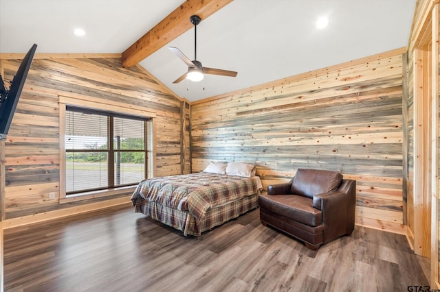 bedroom with wood walls, ceiling fan, hardwood / wood-style flooring, and vaulted ceiling with beams