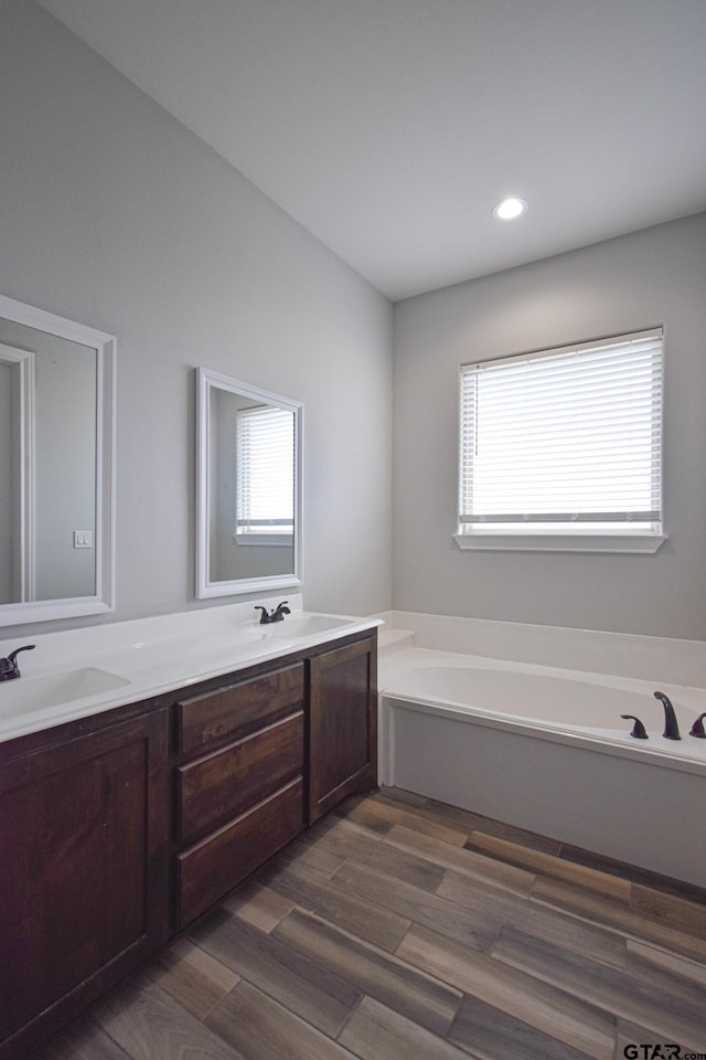 bathroom featuring double vanity, plenty of natural light, and a sink