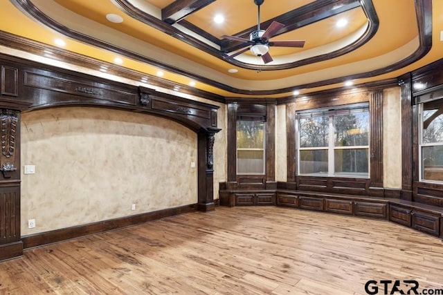 interior space with light wood-type flooring, a healthy amount of sunlight, and crown molding