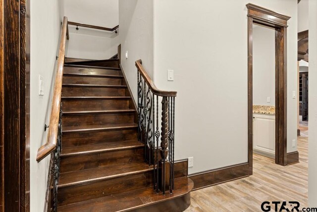 stairs with wood-type flooring