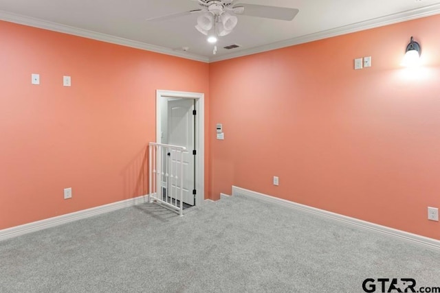 carpeted empty room with ceiling fan and ornamental molding