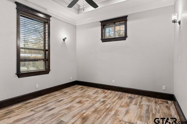 empty room featuring hardwood / wood-style floors, ceiling fan, and crown molding