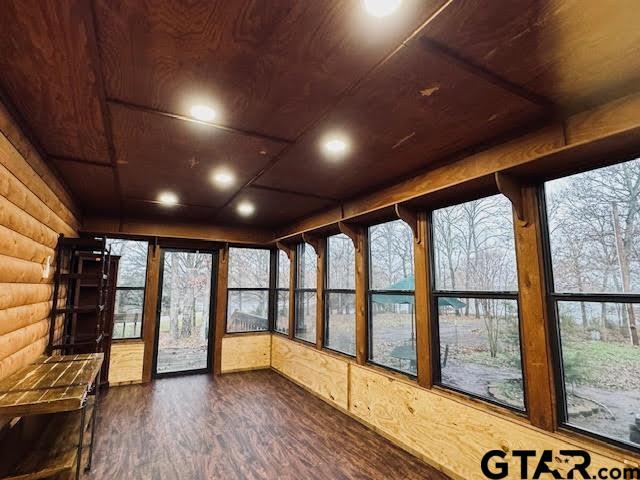 unfurnished sunroom featuring wood ceiling