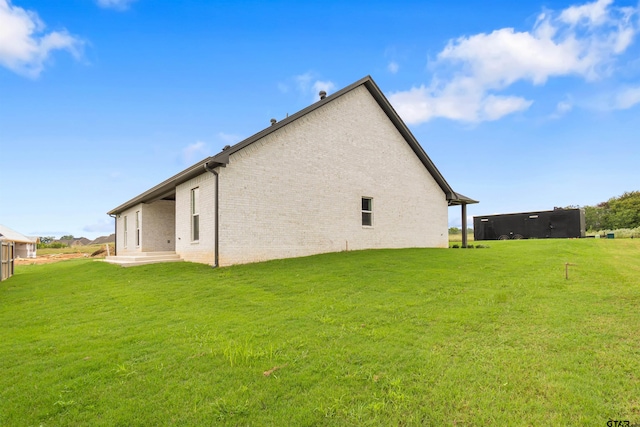 rear view of property featuring a yard