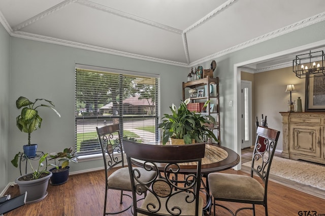 dining area featuring vaulted ceiling, a wealth of natural light, and crown molding