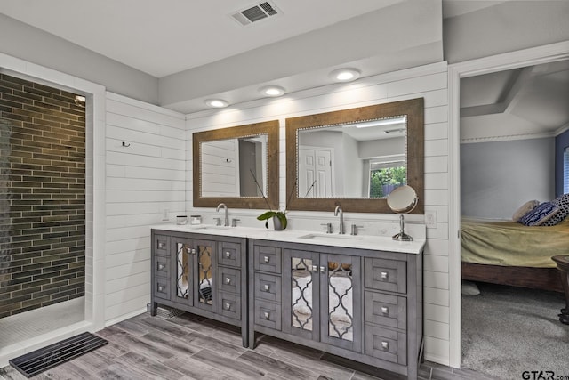 bathroom with walk in shower, hardwood / wood-style flooring, and vanity