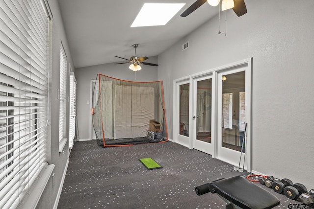 unfurnished sunroom with ceiling fan, lofted ceiling with skylight, and french doors