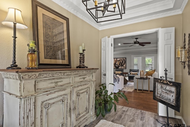 hallway with light hardwood / wood-style floors and ornamental molding