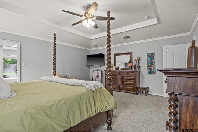 carpeted bedroom featuring ceiling fan, crown molding, and a raised ceiling