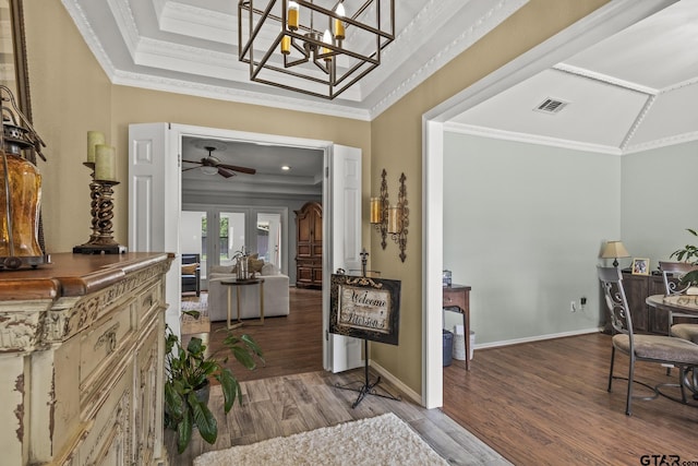 foyer with french doors, ornamental molding, ceiling fan with notable chandelier, and hardwood / wood-style flooring