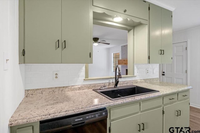 kitchen featuring a sink, backsplash, dishwasher, and green cabinets