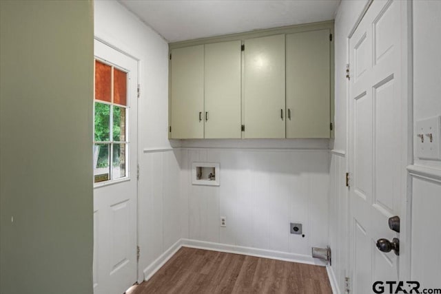 washroom featuring cabinet space, electric dryer hookup, dark wood finished floors, and washer hookup