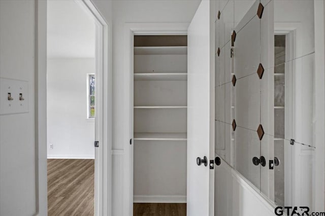 interior space with baseboards and wood finished floors