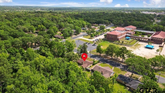 bird's eye view with a wooded view