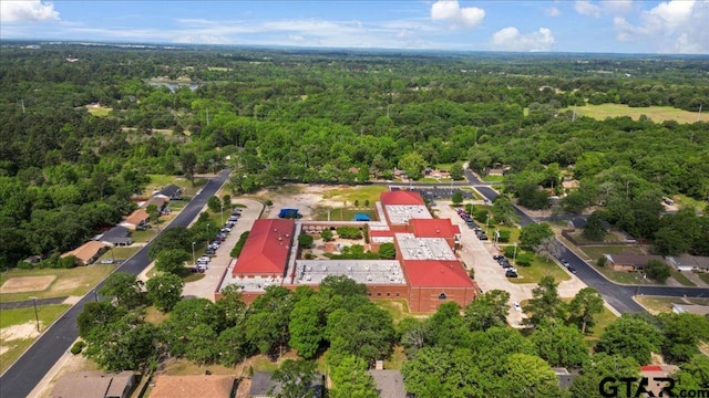 birds eye view of property with a view of trees