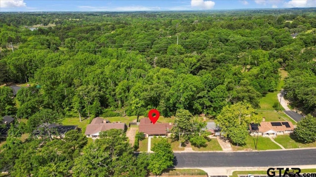 drone / aerial view featuring a view of trees