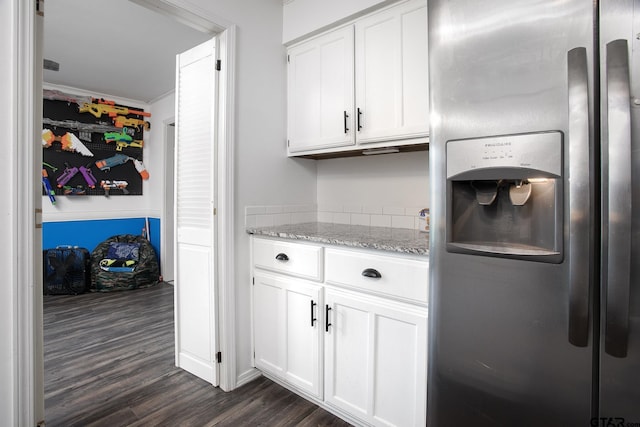 kitchen featuring stainless steel refrigerator with ice dispenser, white cabinets, crown molding, dark wood-style flooring, and light stone counters