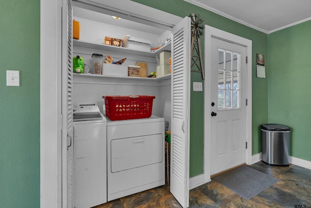 laundry room with washing machine and clothes dryer, crown molding, baseboards, laundry area, and stone finish floor