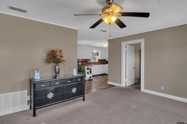 interior space featuring visible vents, dark carpet, and ornamental molding