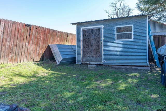 view of outdoor structure with an outbuilding and fence