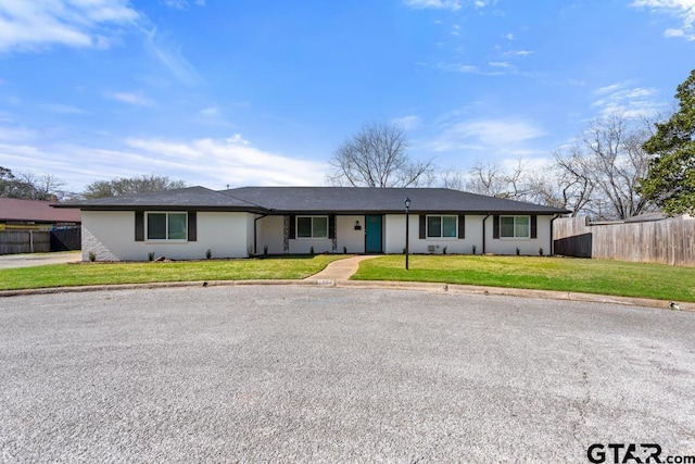 ranch-style house featuring a front lawn