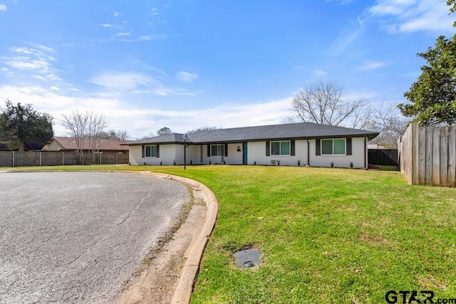 ranch-style home featuring a front yard