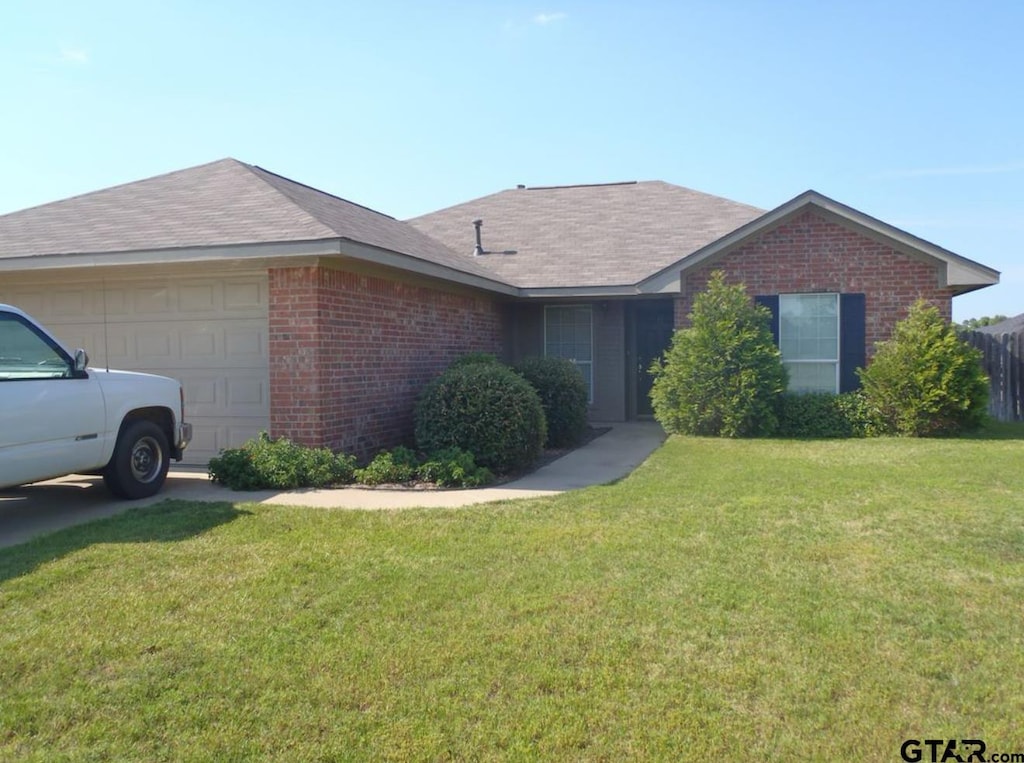 11320 Derby Dr, Flint, TX 75762 - single story home featuring brick siding, a garage, a front lawn, and roof with shingles