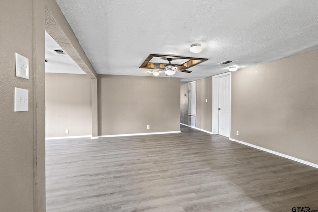 unfurnished room featuring hardwood / wood-style floors, a textured ceiling, and ceiling fan