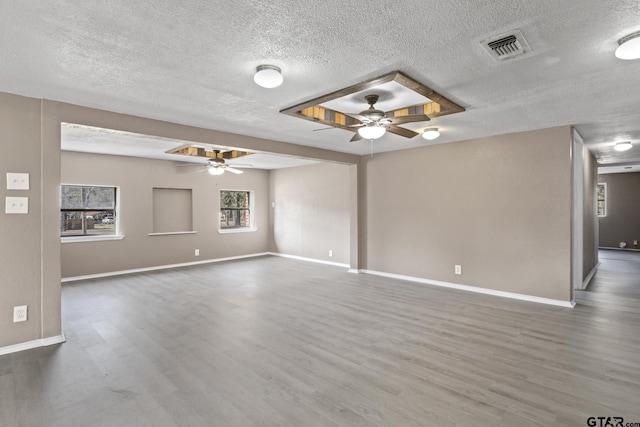 unfurnished room with dark wood-type flooring, ceiling fan, and a textured ceiling