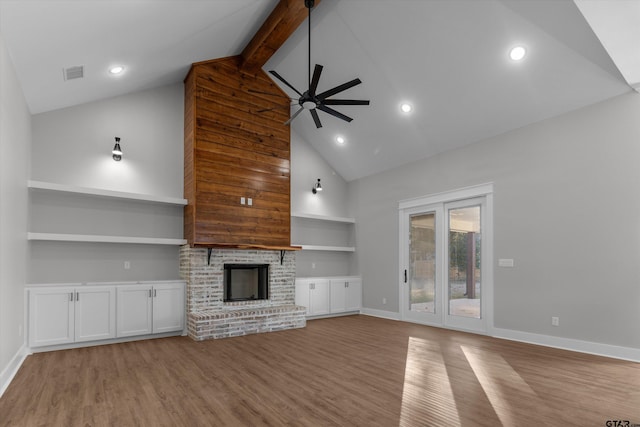 unfurnished living room featuring light hardwood / wood-style floors, beam ceiling, ceiling fan, and a fireplace