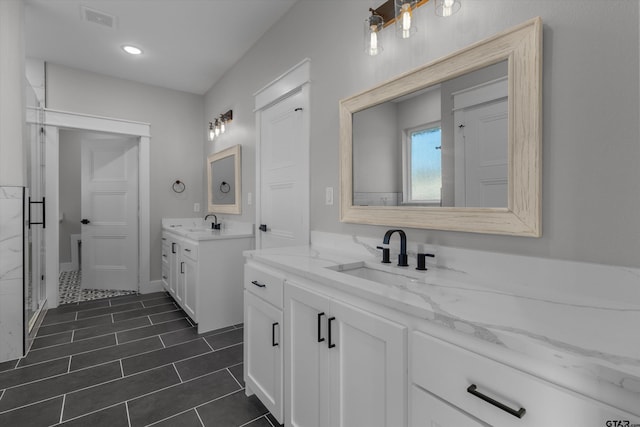 bathroom with vanity and a shower with shower door