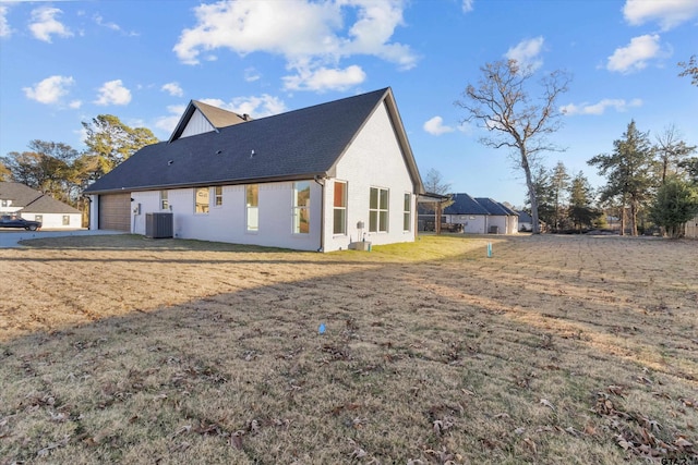 view of home's exterior featuring cooling unit, a garage, and a lawn