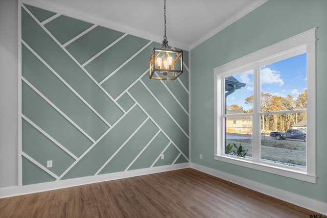 unfurnished dining area with a notable chandelier, plenty of natural light, ornamental molding, and hardwood / wood-style flooring