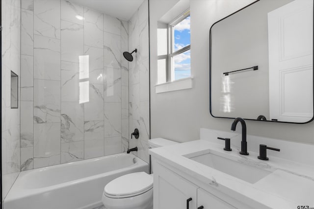 full bathroom with toilet, vanity, and tiled shower / bath