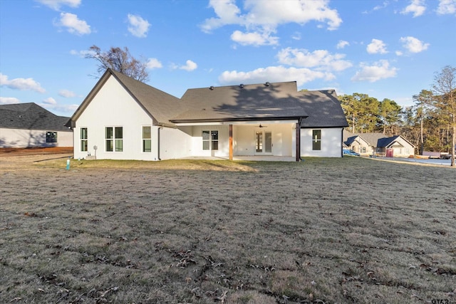 back of house with a patio and a yard