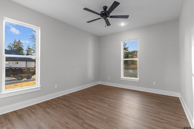 empty room with ceiling fan and hardwood / wood-style floors