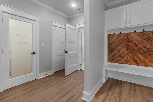 mudroom with ornamental molding and light wood-type flooring