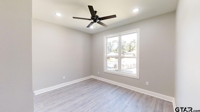 spare room featuring ceiling fan and light hardwood / wood-style floors