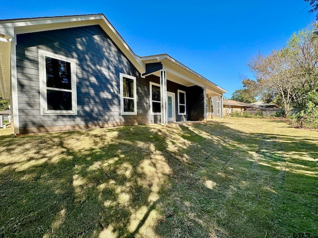 rear view of property with a lawn