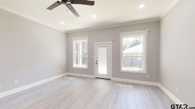 interior space featuring ornamental molding, light hardwood / wood-style flooring, a healthy amount of sunlight, and ceiling fan