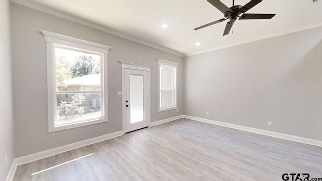 interior space with light wood-type flooring, ceiling fan, and crown molding