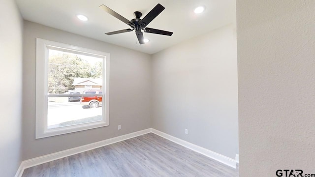 spare room with light hardwood / wood-style floors and ceiling fan