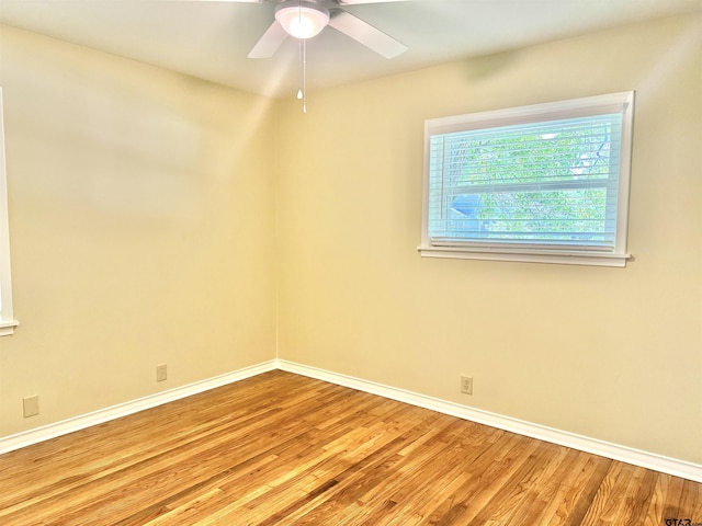 828 Adams St, Jacksonville, TX 75766 - empty room featuring wood finished floors, baseboards, and ceiling fan
