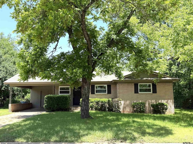828 Adams St, Jacksonville, TX 75766 - ranch-style house featuring brick siding, a front yard, concrete driveway, and a carport