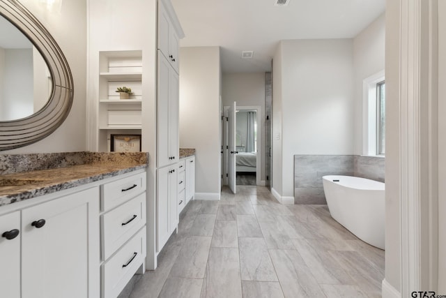 261 Heritage Way, Bullard, TX 75757 - ensuite bathroom featuring vanity and a freestanding tub
