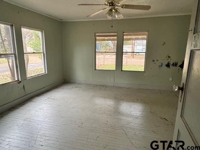 unfurnished room with ceiling fan, crown molding, and light hardwood / wood-style floors