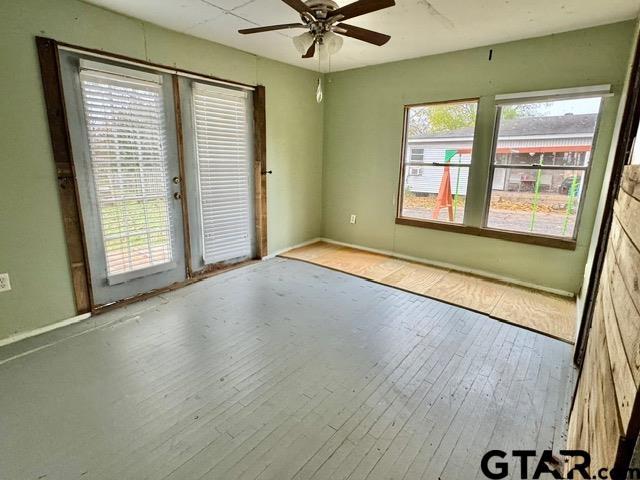 spare room featuring ceiling fan and light hardwood / wood-style flooring