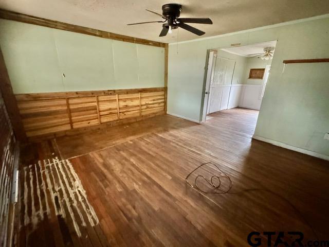 spare room featuring hardwood / wood-style floors and ceiling fan