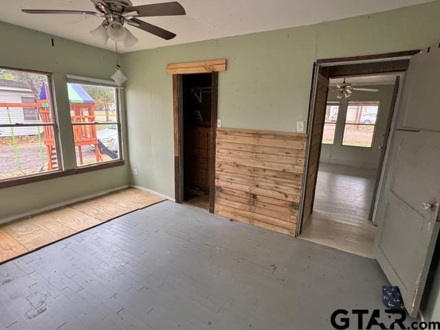 empty room with a wealth of natural light and ceiling fan